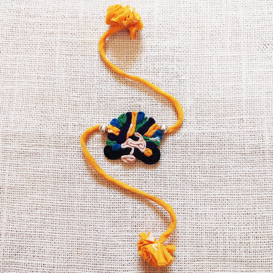 Handmade Dori Work Ethnic Rabari Rakhi With Roli Chawal - Flat Lay Orange Thread Bracelet