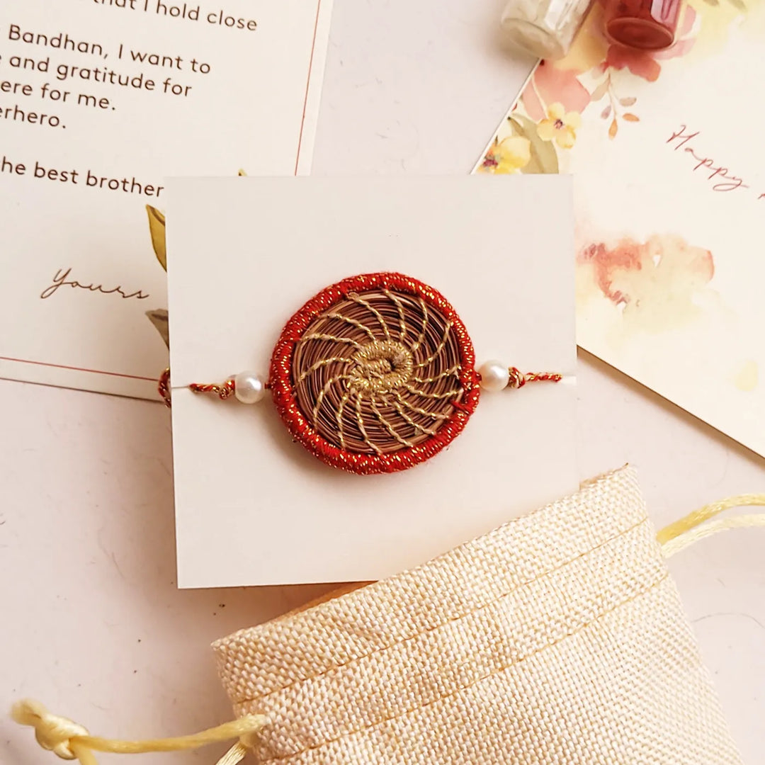 Eco Friendly Handmade Gold And Red Pine Needle Rakhi With Pouch And Roli Chawal - Alternate Front View