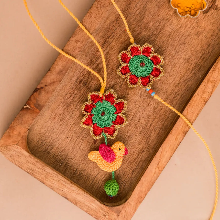 Handmade Crochet Phool And Chidiya Bhaiya Bhabhi Rakhi With Roli Chawal Set Of 2 - Close-up of decorative rakhi