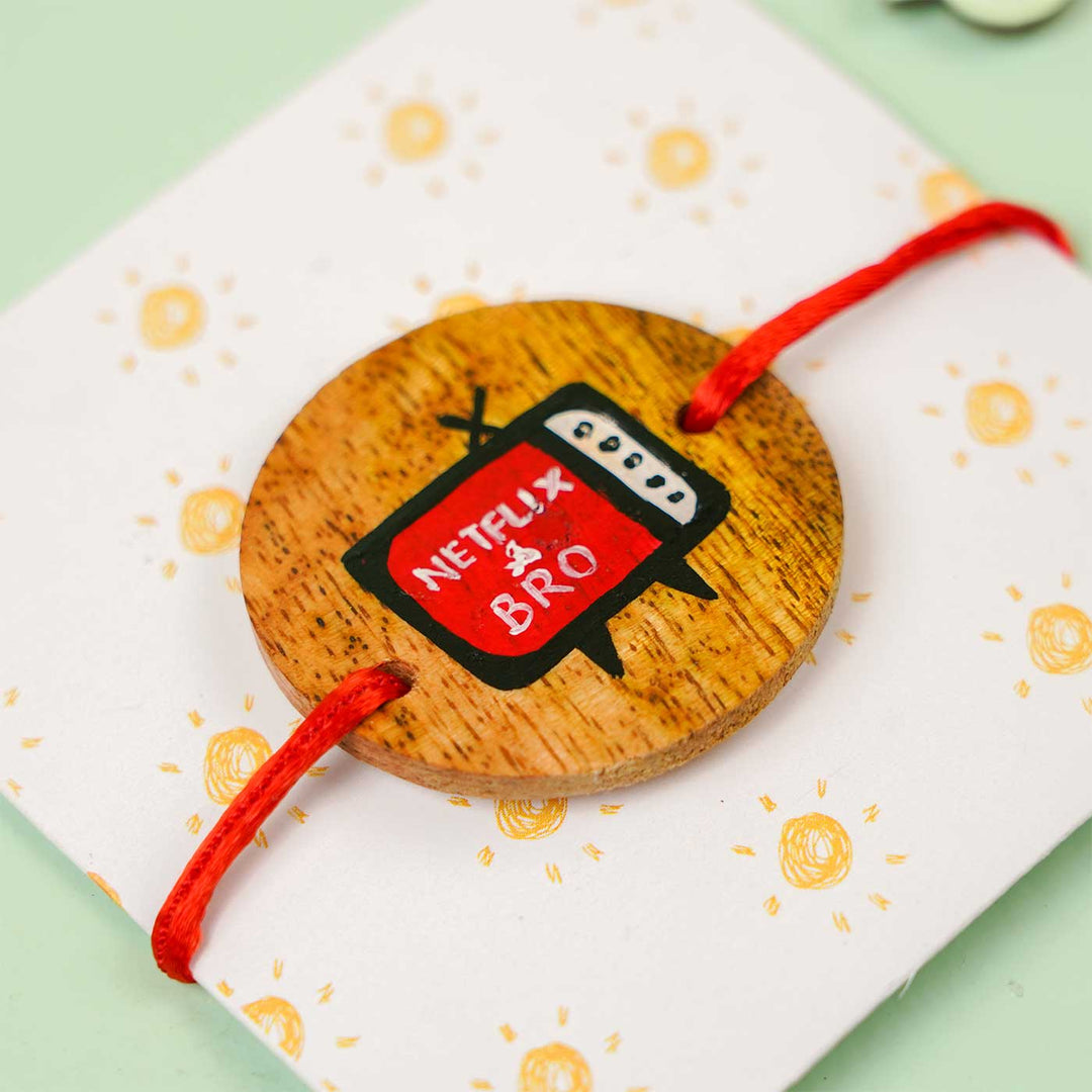 Personalized Hand Painted Netflix Bro Wooden Rakhi With Roli Chawal - Angled Close-up on Packaging