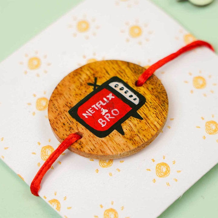 Personalized Hand Painted Netflix Bro Wooden Rakhi With Roli Chawal - Angled Close-up on Packaging