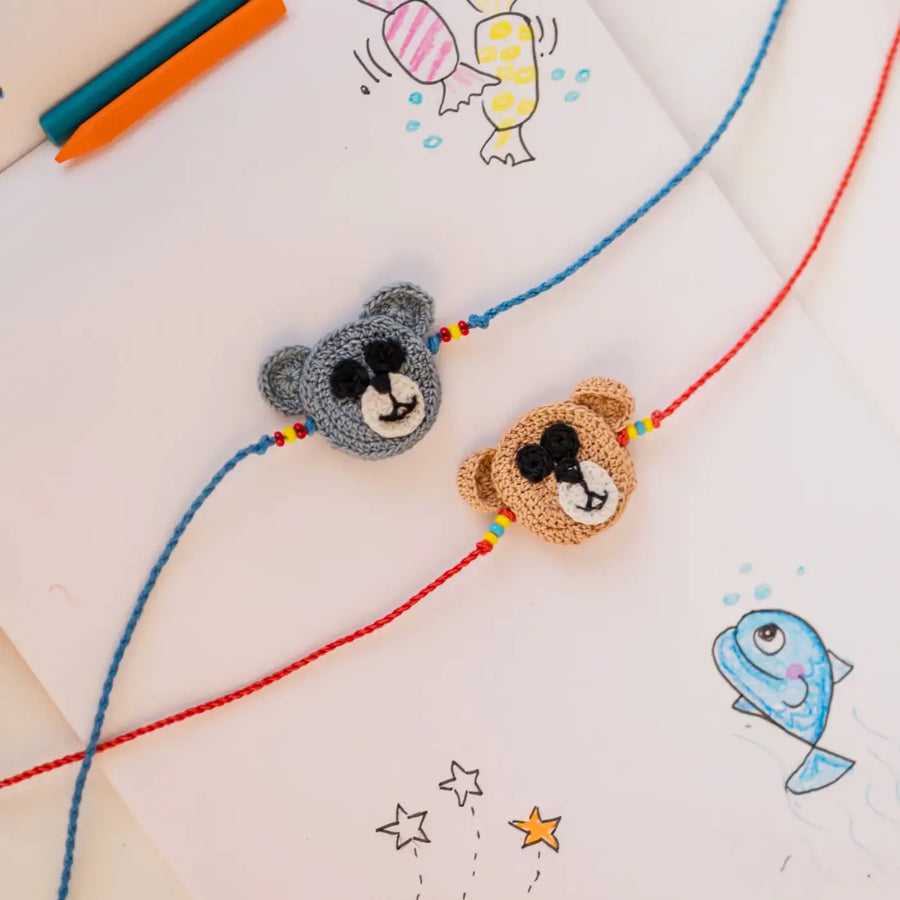 Handmade Crochet Grey And Brown Bear Theme Kids Rakhi With Roli Chawal Set Of 2 - Flat Lay with Bear Faces