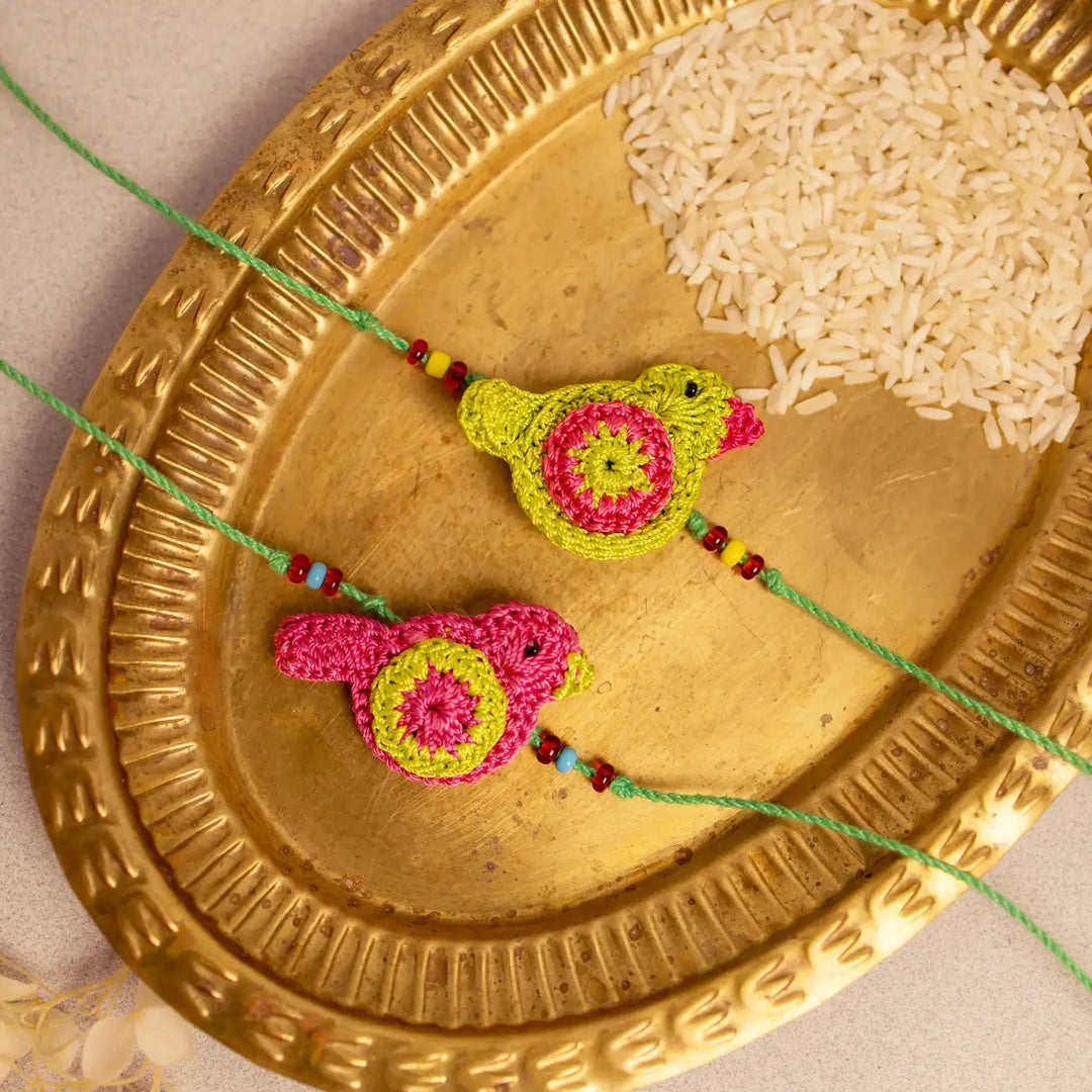Handmade Crochet Green And Pink Birds Rakhi With Roli Chawal Set Of 2 - Close-up Showing Bead Details
