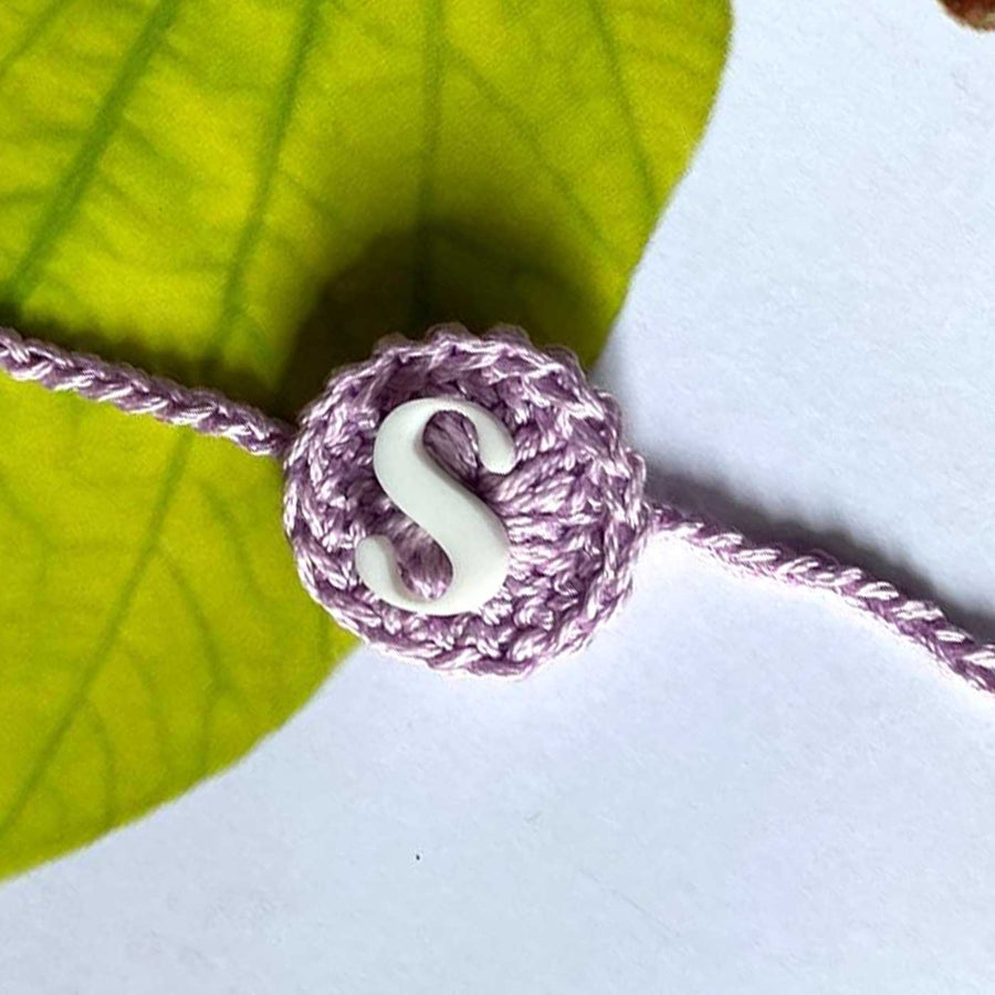 Personalized Handmade Crochet Round Shape Cotton Rakhi With Roli Chawal - Close-up of Crocheted Initial Charm