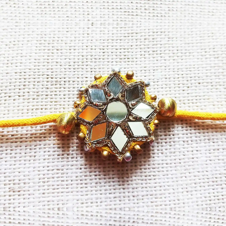Handmade Beaded Mirror Work Rakhi With Roli Chawal - Close-up of central design