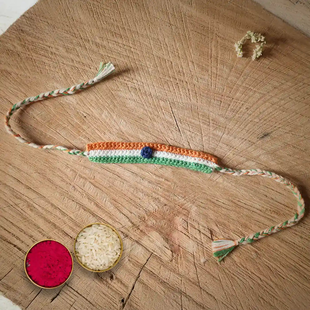 Handmade Crochet Indian Flag Band Rakhi With Roli Chawal - Flat Lay with Decorative Bowls