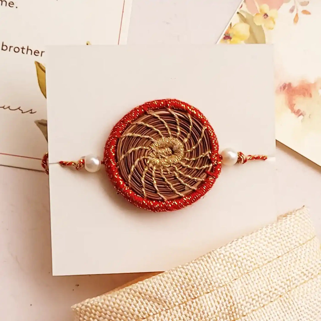 Eco Friendly Handmade Gold And Red Pine Needle Rakhi With Pouch And Roli Chawal - Front View