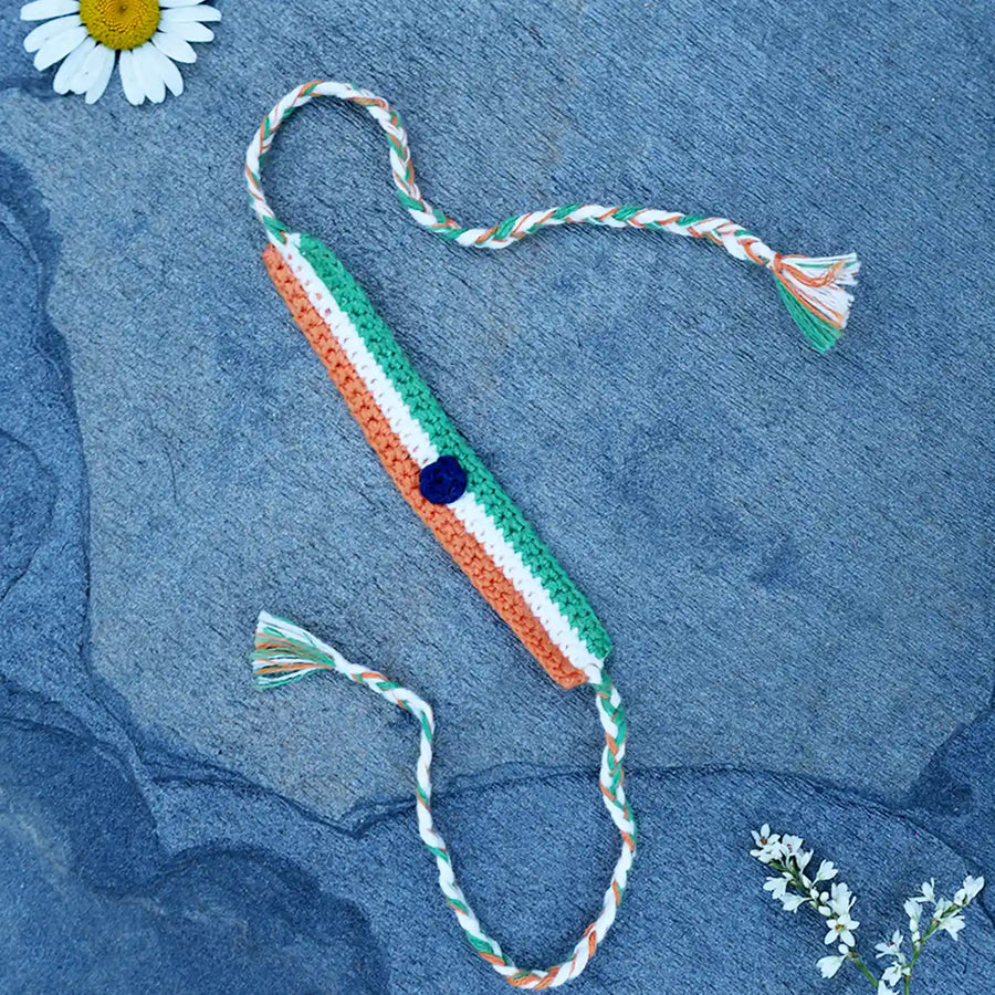 Handmade Crochet Indian Flag Band Rakhi With Roli Chawal - Flat Lay with Flower Accents