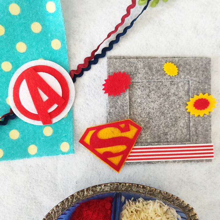 Photo Personalized Superman And Avengers Theme Felt Rakhi Hamper With Roli Chawal Includes 1 Magnetic Photo Frame 1 Rakhi - Decorative Felt Frame with Designs