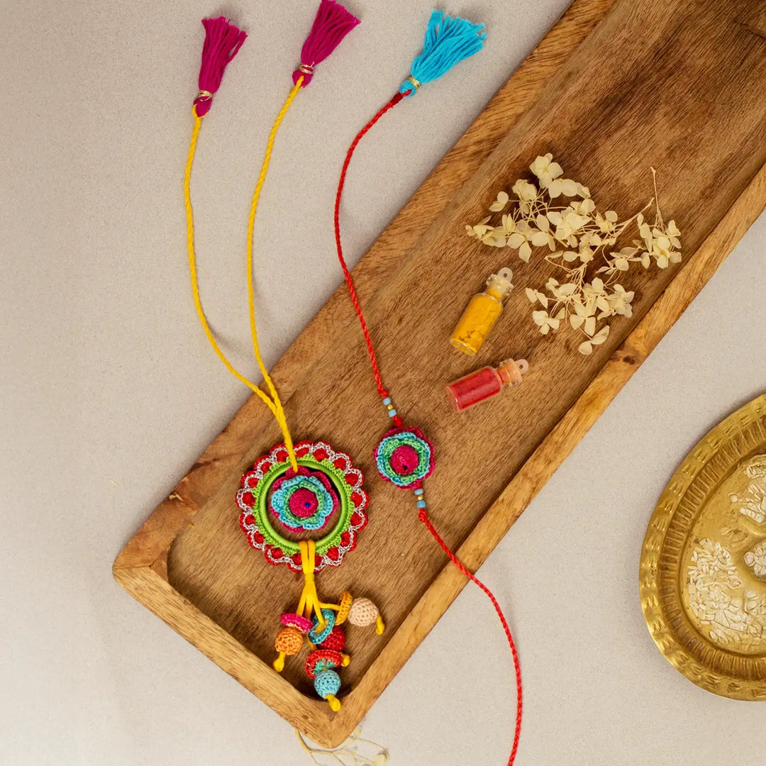 Handmade Crochet Rose Bhaiya Bhabhi Rakhi With Roli Chawal Set Of 2 - Top view with accessories arranged