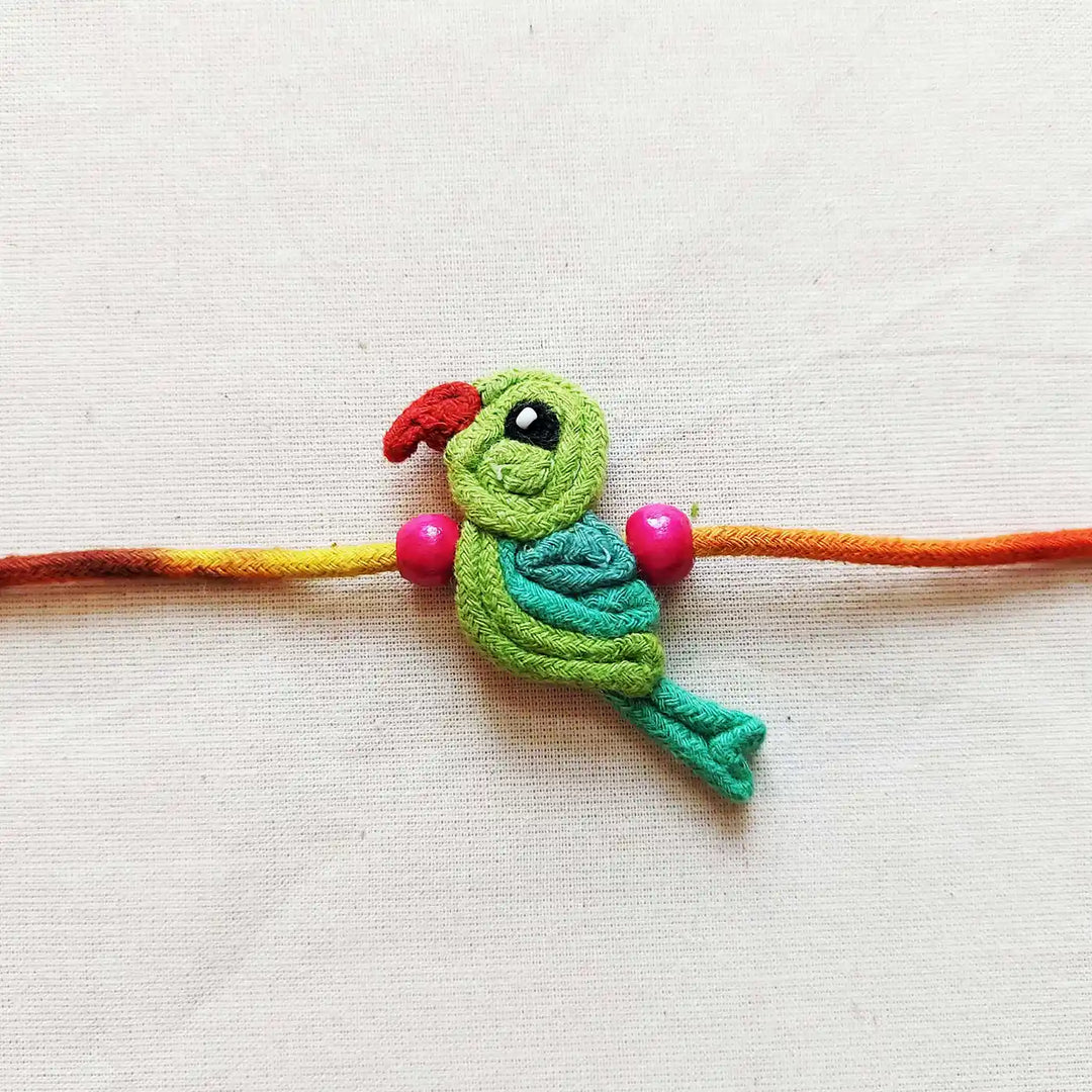 Handmade Dori Work Cute Parrot Kids Rakhi With Roli Chawal - Close-up of Central Design