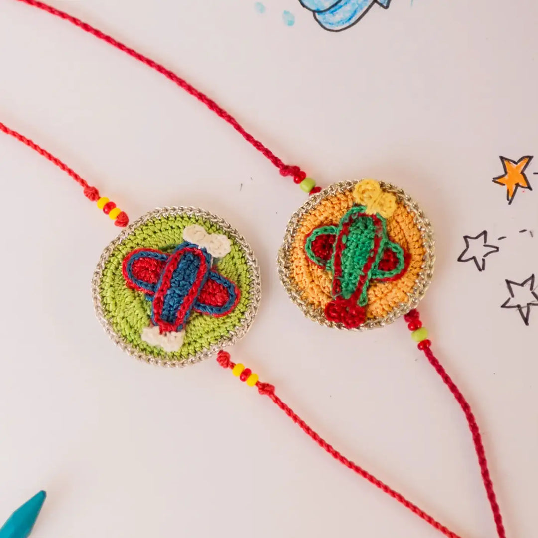 Handmade Crochet Airplane Theme Kids Rakhi With Roli Chawal Set Of 2 - Close-up of Embroidered Charms