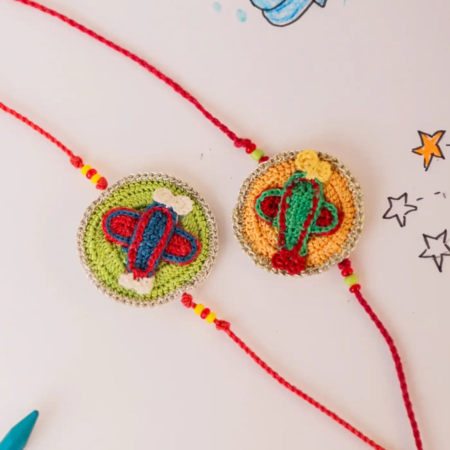 Handmade Crochet Airplane Theme Kids Rakhi With Roli Chawal Set Of 2 - Close-up of Embroidered Charms