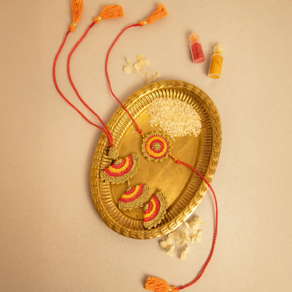 Handmade Crochet Tarang Bhaiya Bhabhi Rakhi With Roli Chawal Set Of 2 - Flat Lay Close-up on Brass Tray