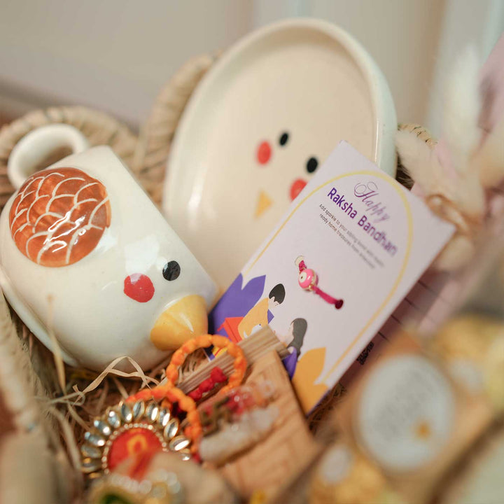 Personalized Handmade Foodie Theme Rakhi Hamper Includes 1 Basket 1 Plate 1 Mug 1 Rakhis 1 Roli Chawal 1 Chocolate And 1 Message Card - Close-up of Basket Contents