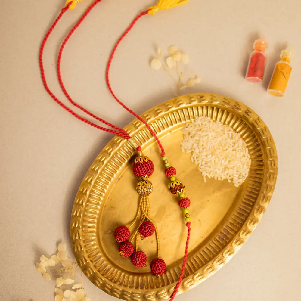 Handmade Crochet Rudraksh Bhaiya Bhabhi Rakhi With Roli Chawal Set Of 2 - Full product layout on decorative tray