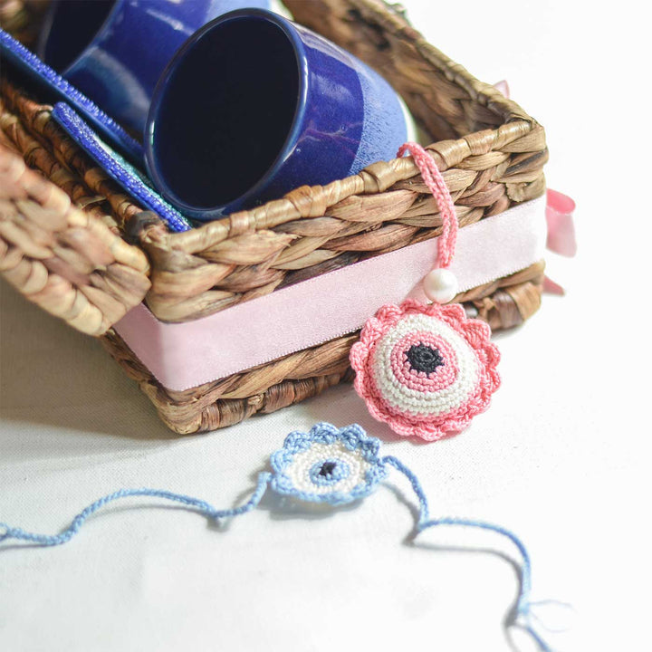 Handmade Crochet Evil Eye Design Cotton Rakhi - Two Bracelets Next to Basket Edge