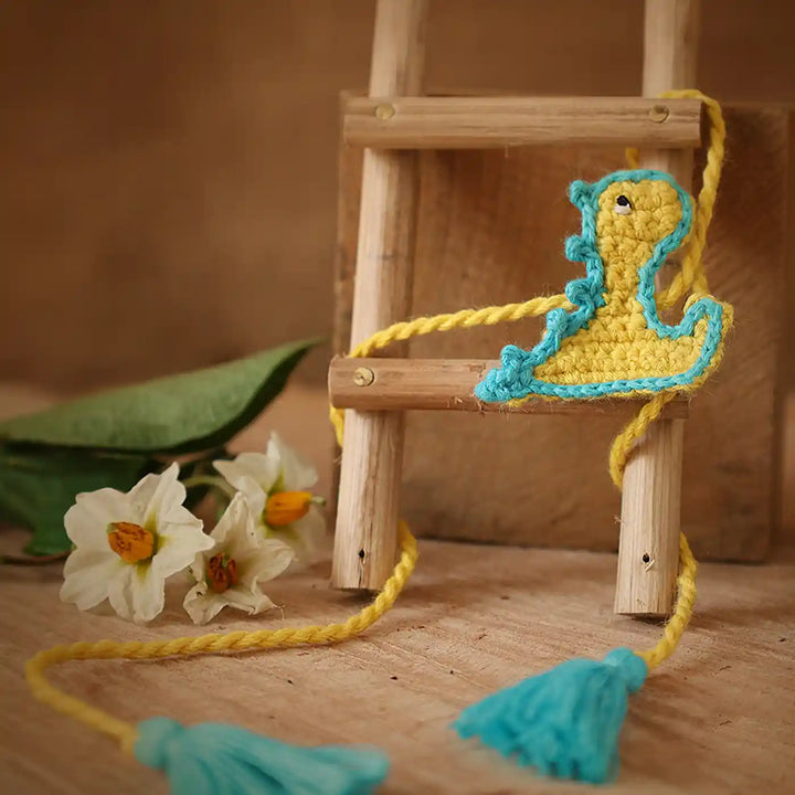 Handmade Crochet Baby Dragon Theme Kids Rakhi And Toy Combo With Roli Chawal Set Of 2 - Ladder Accessory Close-up with Tassels