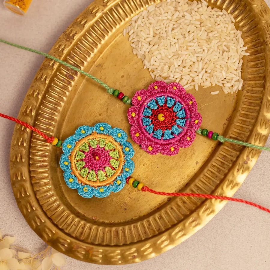 Handmade Crochet Floral Noor Rakhi With Roli Chawal Set Of 2 - Close-up of Crochet Rakhi Pair
