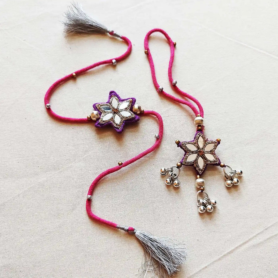 Handmade Mirror Work And Ghungroo Bhaiya Bhabhi Rakhi With Roli Chawal Set Of 2 - Pair Display on Cloth Surface