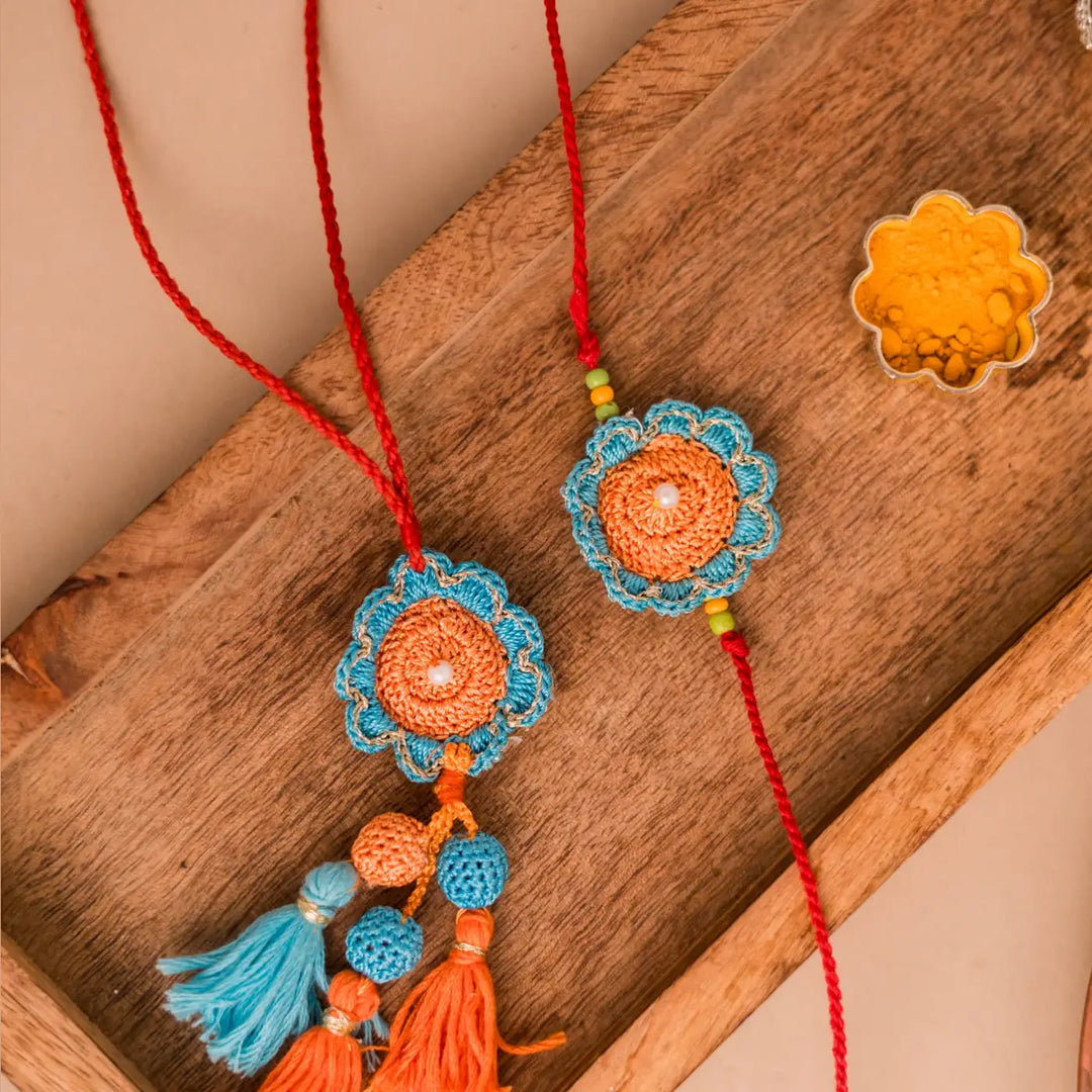 Handmade Crochet Blue And Orange Camelia Bhaiya Bhabhi Rakhi With Roli Chawal Set Of 2 - Close-up on Tassel Details