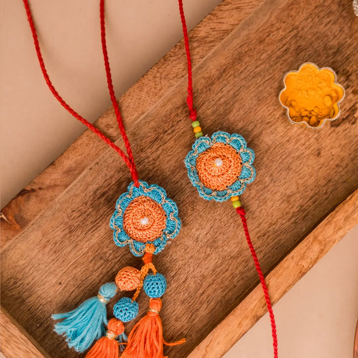 Handmade Crochet Blue And Orange Camelia Bhaiya Bhabhi Rakhi With Roli Chawal Set Of 2 - Close-up on Tassel Details