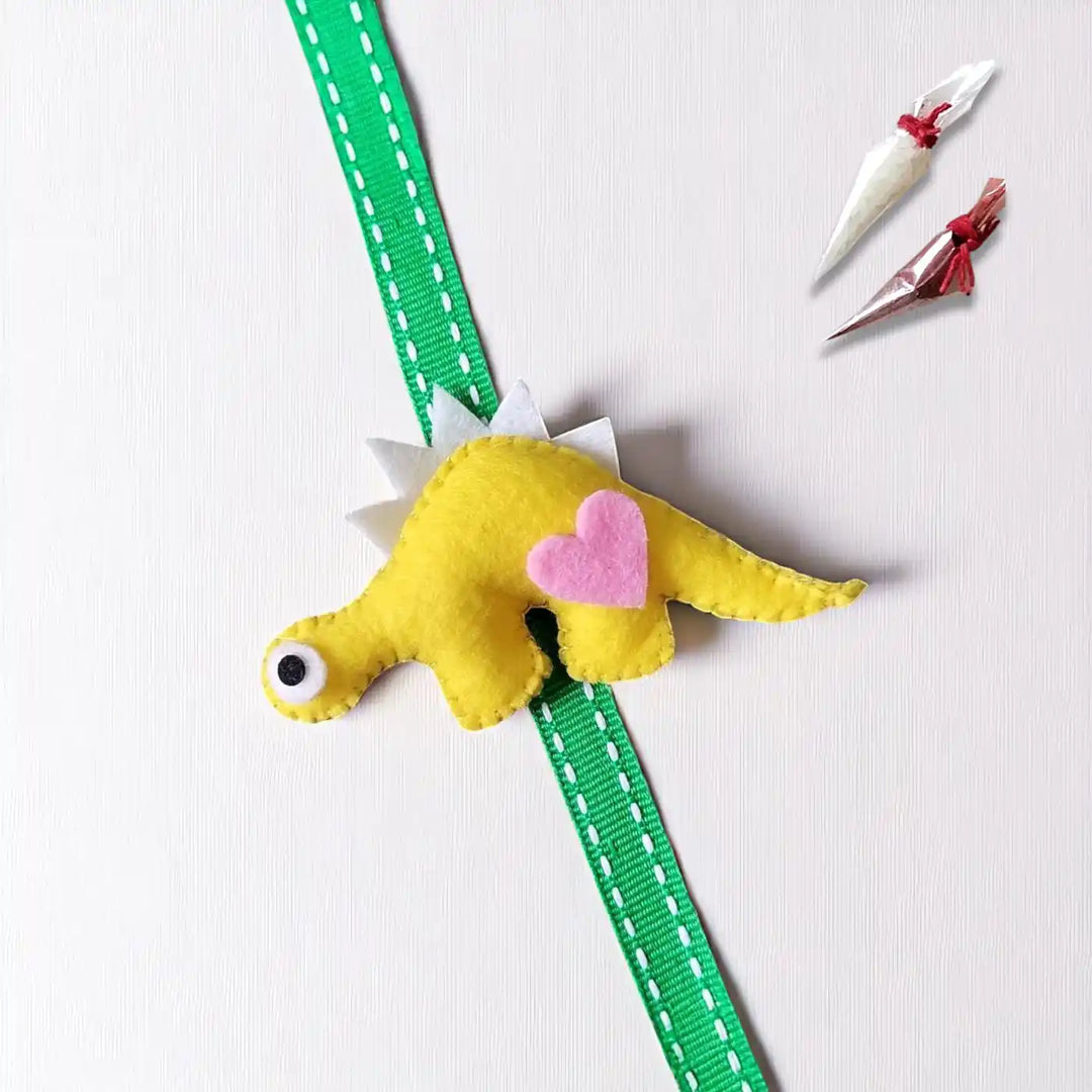 Handmade Dino Theme Felt Kids Rakhi With Roli Chawal - Flat Lay with Accessories (4)