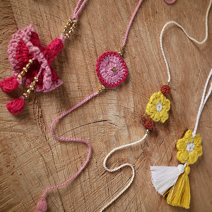 Handmade Crochet Pink And Yellow Bhaiya Bhabhi Rakhi With Roli Chawal Set Of 4 - Close-up View Showing Details