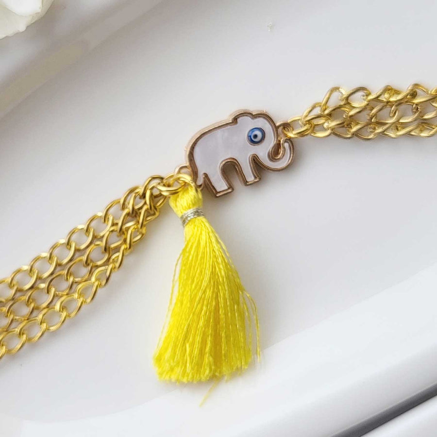 Handmade Elephant Design Bracelet Rakhi Hamper With Roli Chawal For Sisters - Close-up of elephant charm bracelet