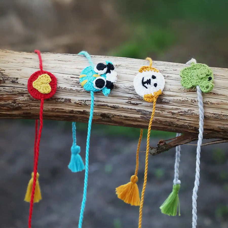 Handmade Crochet Owl Elephant Dog And Heart Kids Rakhi With Roli Chawal Set Of 4 - Displayed Hanging on Branch
