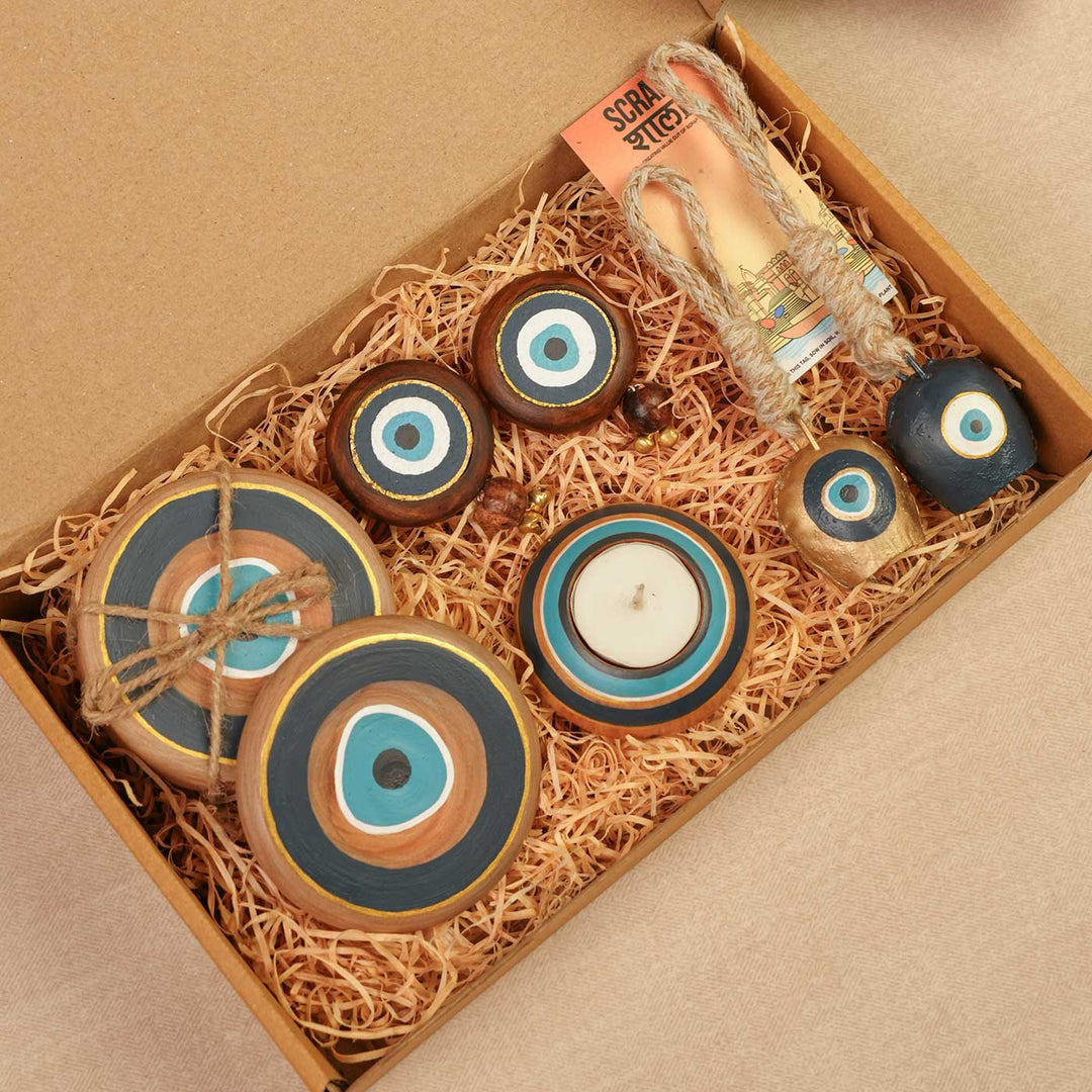Handmade Divya Drishti Gift Hamper | Includes Evil Eye Door Hanging, Evil Eye Coasters, Evil Eye Candle Stand, Evil Eye Bell Hangings, Seed Card And Outer Box