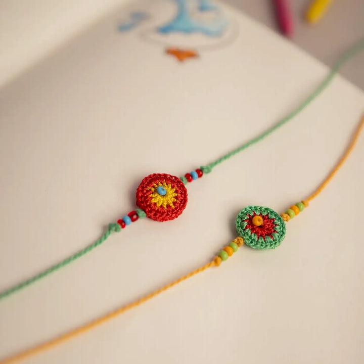 Handmade Crochet Green And Orange Ziba Rakhi With Roli Chawal Set Of 2 - Side View Showing Bead Details