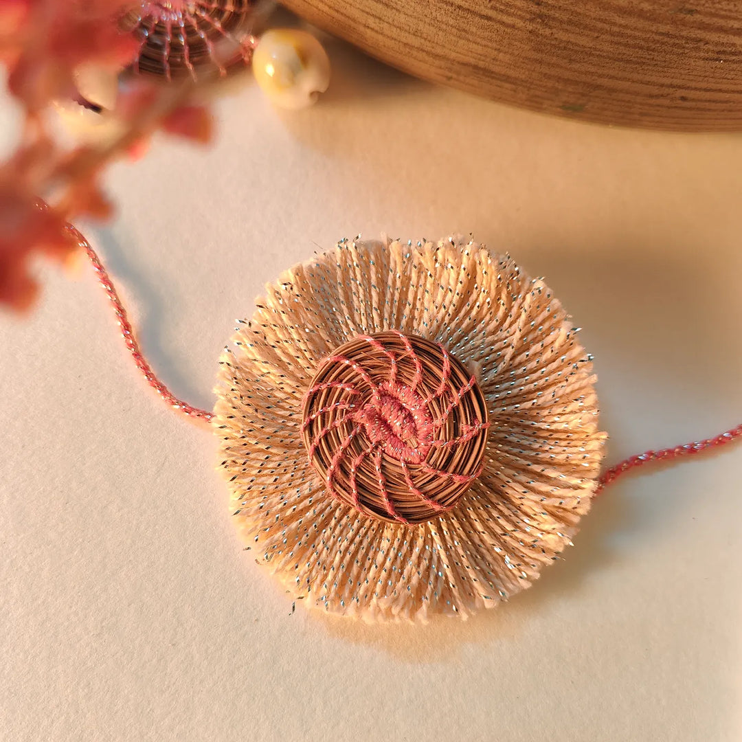 Eco Friendly Handmade White And Pink Pine Needle Rakhi With Pouch And Roli Chawal - Close-up of Rakhi Decoration