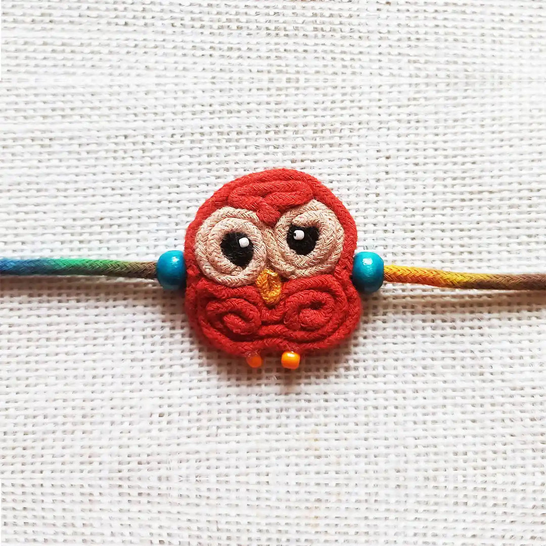 Handmade Dori Work Cute Owl Kids Rakhi With Roli Chawal - Close-up Front View