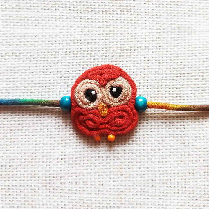 Handmade Dori Work Cute Owl Kids Rakhi With Roli Chawal - Close-up Front View