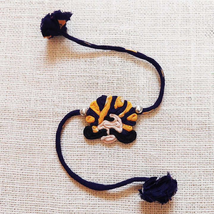 Handmade Dori Work Ethnic Rabari Rakhi With Roli Chawal - Flat Lay Purple Thread Bracelet
