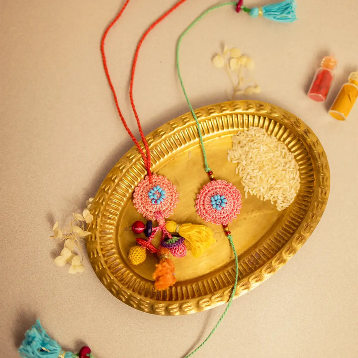 Handmade Crochet Pink Poppy Bhaiya Bhabhi Rakhi With Roli Chawal Set Of 2 - Styled on Decorative Tray