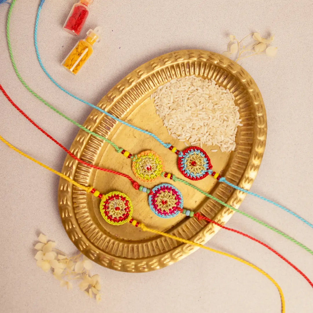 Handmade Crochet Multicolour Mandala Rakhi With Roli Chawal Set Of 4 - Top View with Decorative Elements