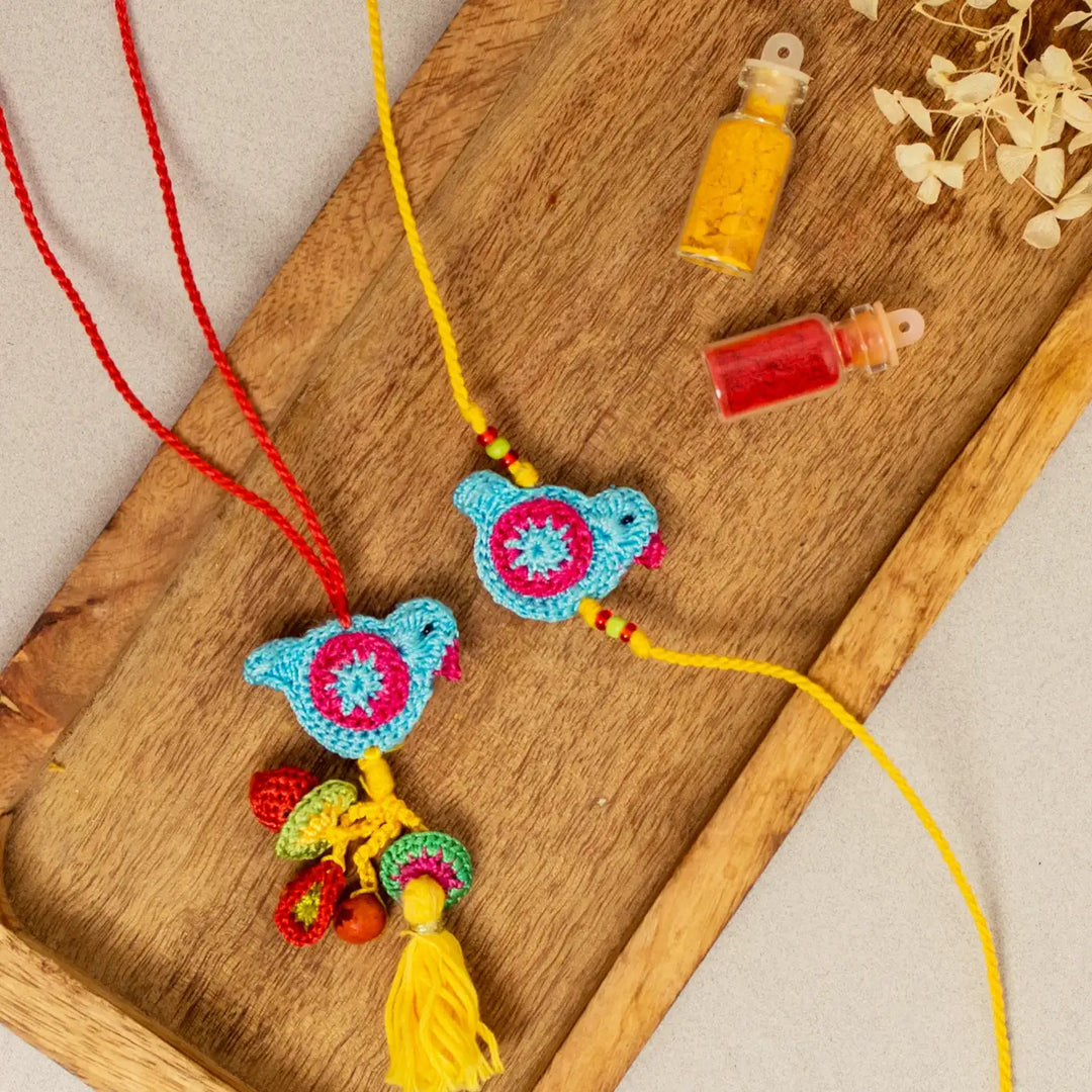 Handmade Crochet Blue Birds Bhaiya Bhabhi Rakhi With Roli Chawal Set Of 2 - Bird charms with spice bottles