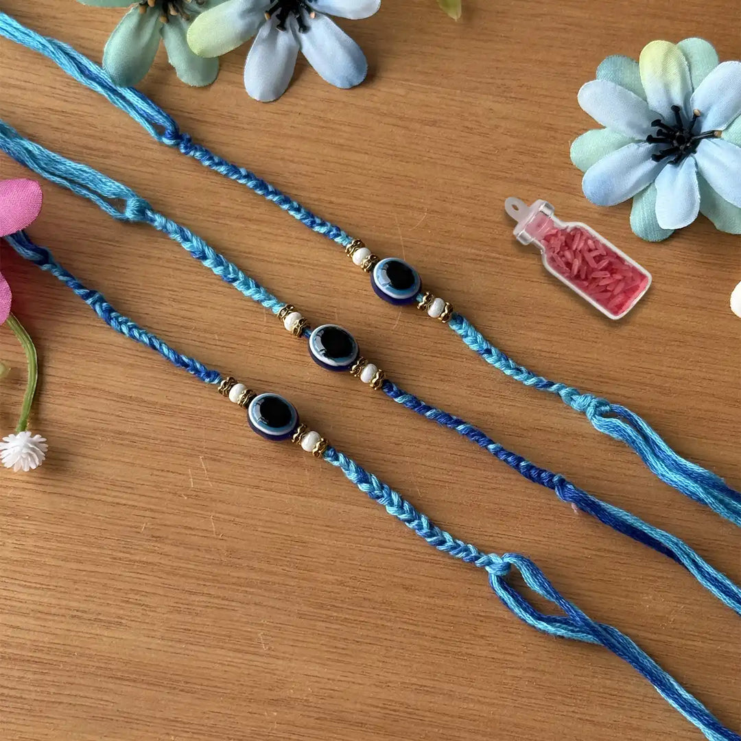 Handmade Beaded Evil Eye Rakhi With Roli Chawal - Three Bracelets Laid Flat
