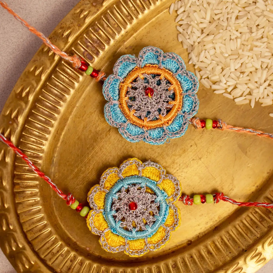 Handmade Crochet Palash Rakhi With Roli Chawal Set Of 2 - Close-up of Thread Flower Rakhis