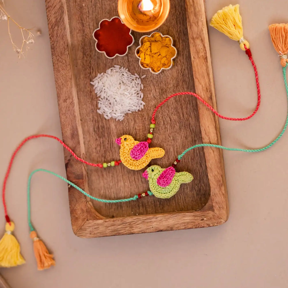 Handmade Crochet Yellow And Green Chidiya Rakhi With Roli Chawal Set Of 2 - Decorative Setup with Ritual Items