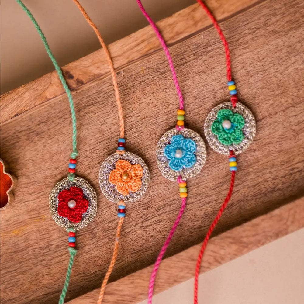 Handmade Crochet Multicolor Embellished Geraniums Rakhi With Roli Chawal Set Of 4 - Flat Lay Close-up Detail
