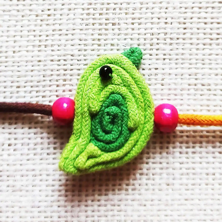 Handmade Dori Work Cute Bird Kids Rakhi With Roli Chawal - Close-up of central charm