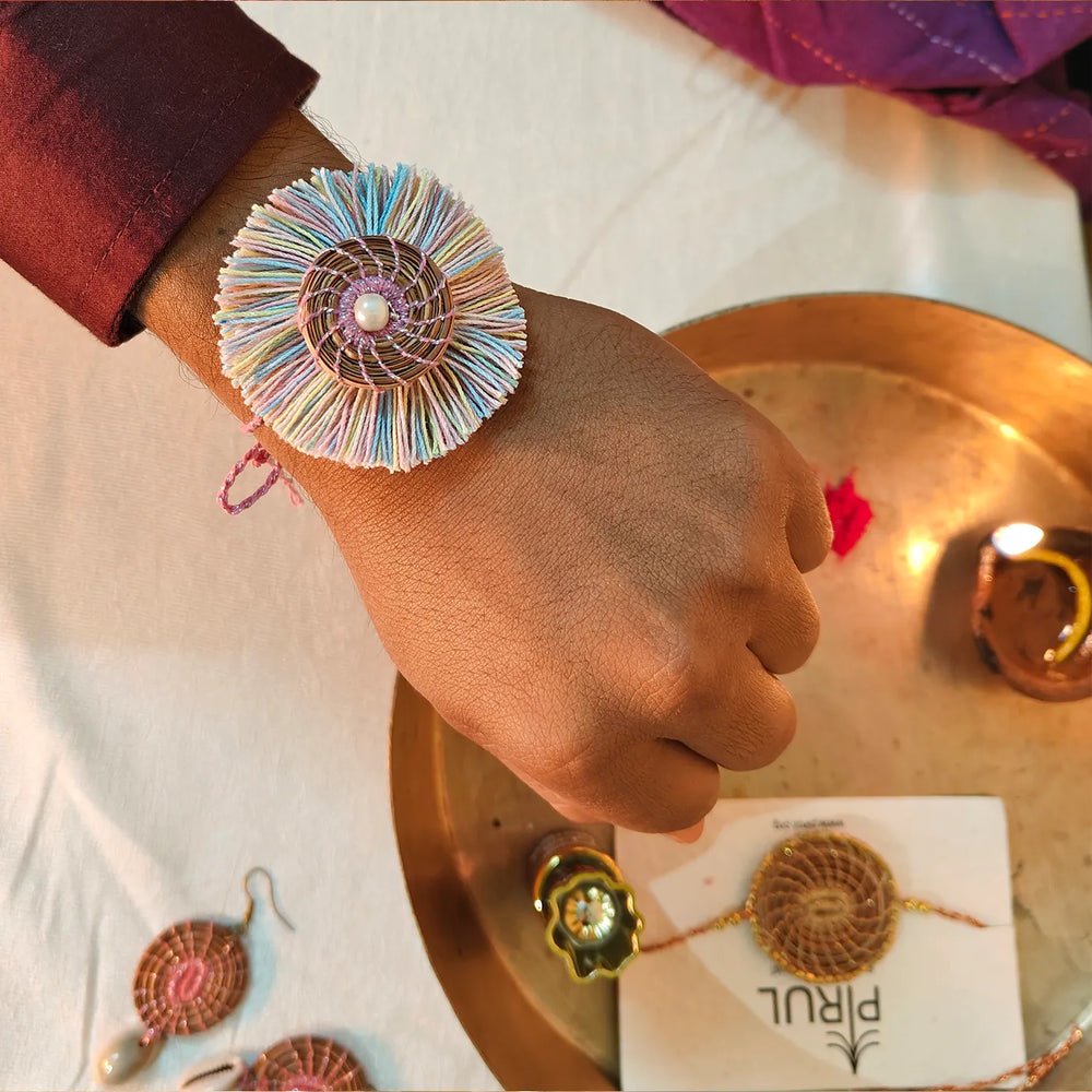 Eco Friendly Handmade Pastel Colour Pine Needle Rakhi With Pouch And Roli Chawal - Wrist View Wearing Bracelet