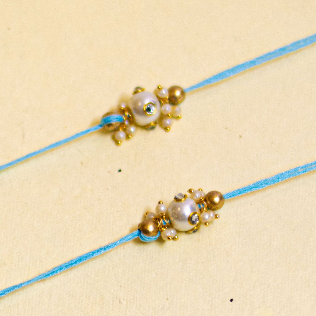 Handmade Basra Pearl Rakhi With Roli Chawal - Detailed close-up of blue bracelets
