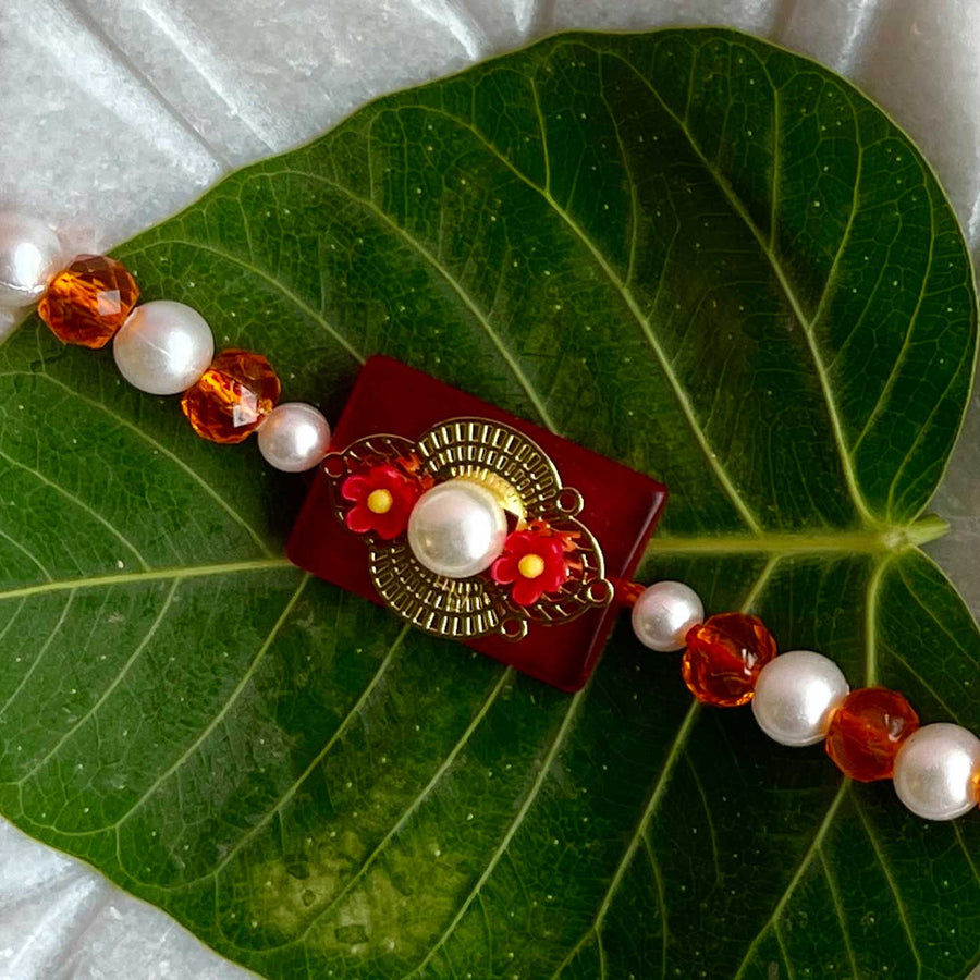 Handmade Flower Design Pearl And Stone Bhaiya Bhabhi Rakhi - Close-up on Rakhi beads and design