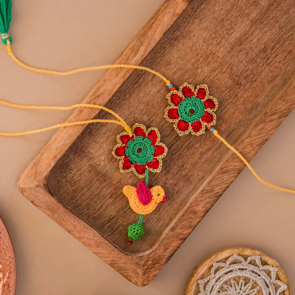 Handmade Crochet Phool And Chidiya Bhaiya Bhabhi Rakhi With Roli Chawal Set Of 2 - Top view of two rakhis