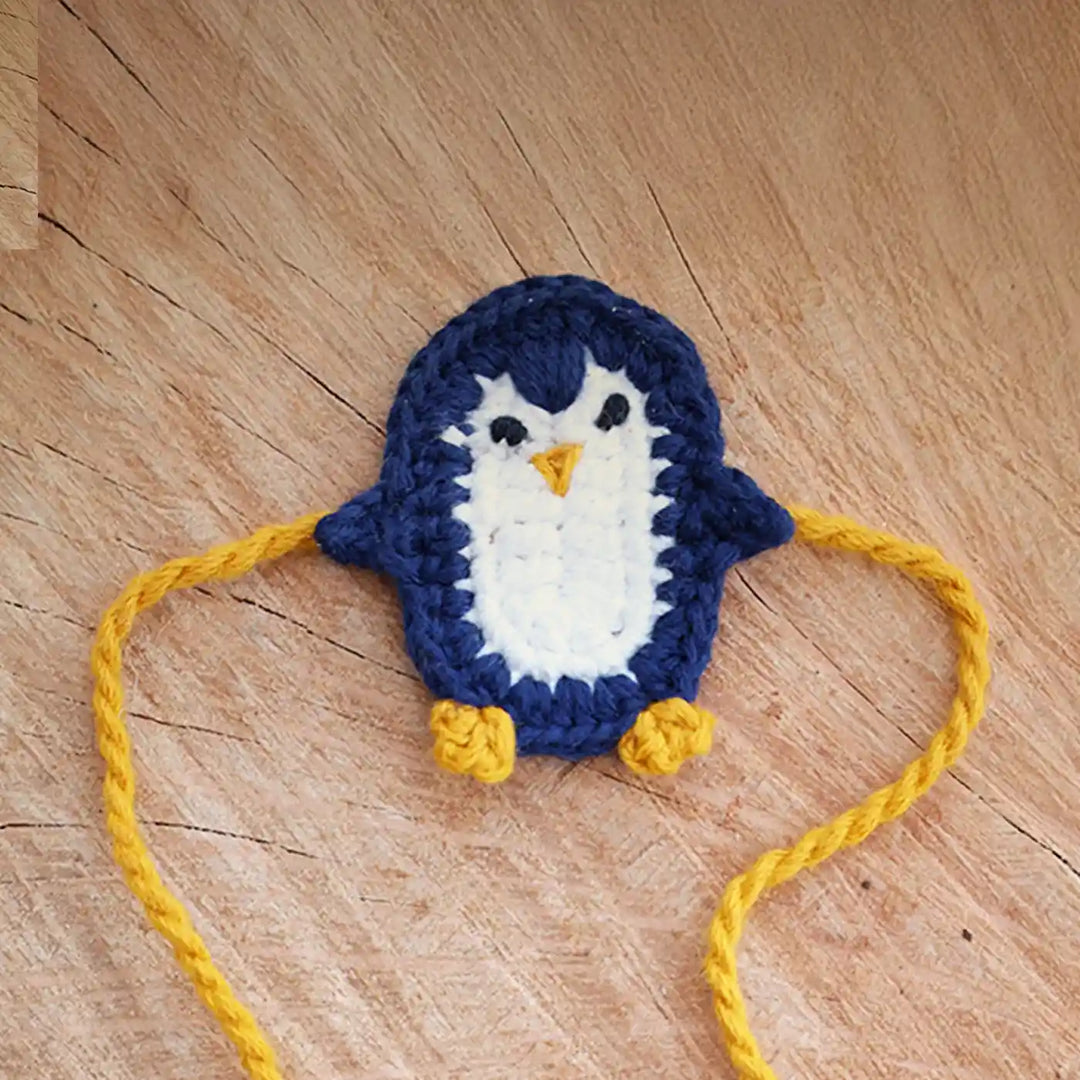 Handmade Crochet Penguin Theme Kids Rakhi And Toy Combo With Roli Chawal Set Of 2 - Close-up of Accessory Detail