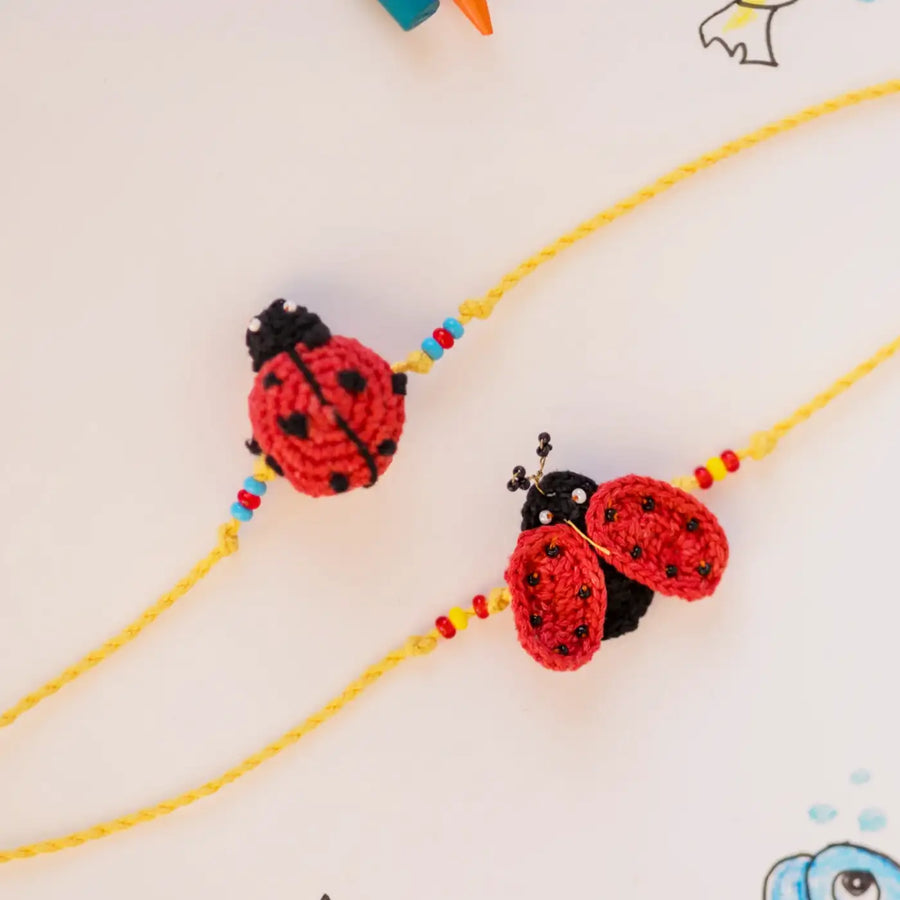 Handmade Crochet Mood Beetles Theme Kids Rakhi With Roli Chawal Set Of 2 - Close-up of Ladybug Charms